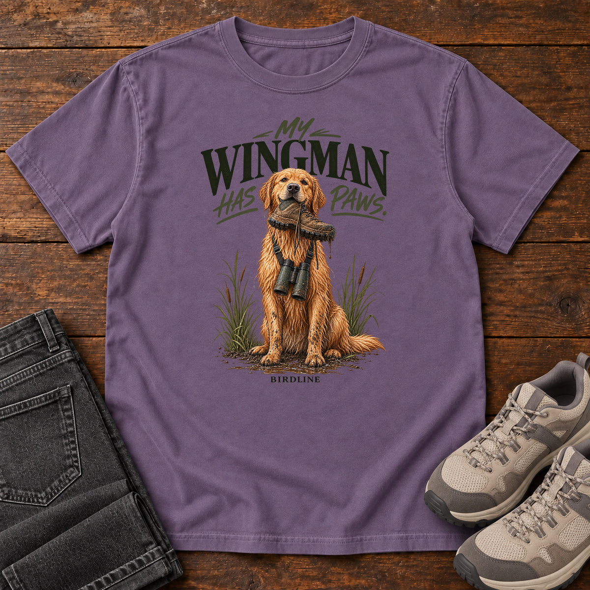 Grape My Wingman Has Paws Retriever T-Shirt with a seated golden dog wearing binoculars beneath the slogan, front flat lay on wood.