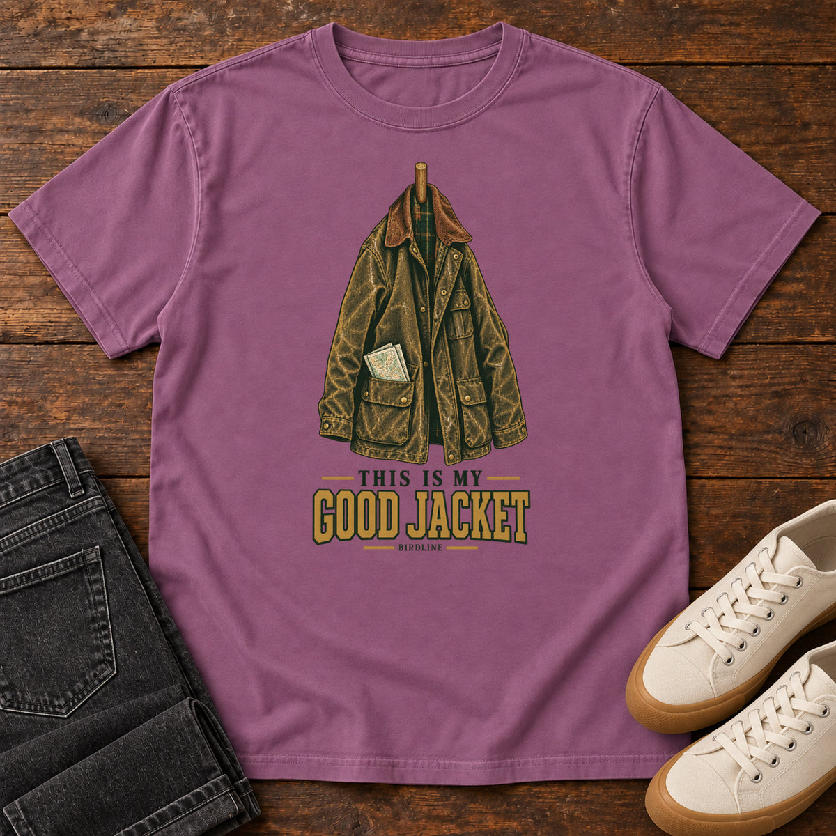 Berry This Is My Good Jacket T-Shirt with a hanging outdoor jacket and This Is My Good Jacket lettering; front flat lay on wood.