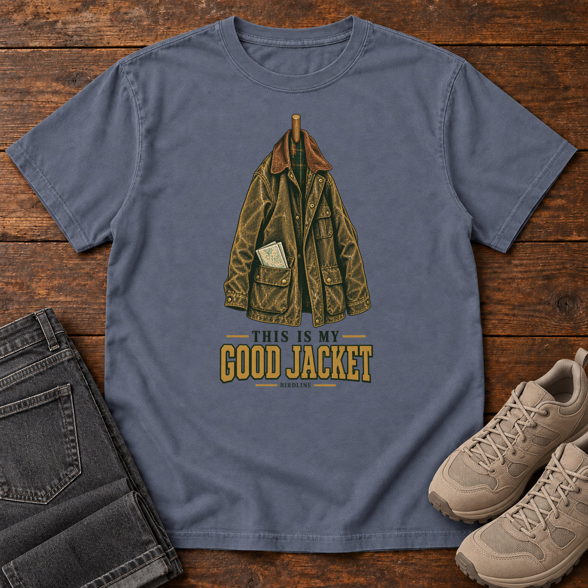 Denim This Is My Good Jacket T-Shirt with a hanging outdoor jacket and This Is My Good Jacket lettering; front flat lay on wood.