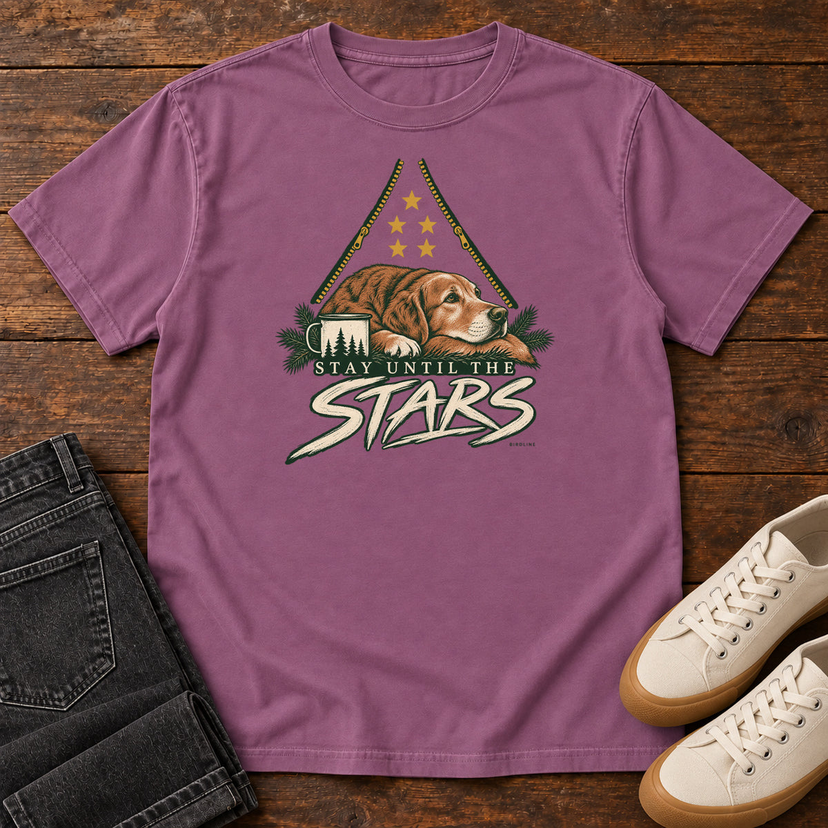 Berry Stay Until the Stars T-Shirt with a resting brown dog beside a camp mug beneath gold stars and cream lettering, front flat lay on wood.