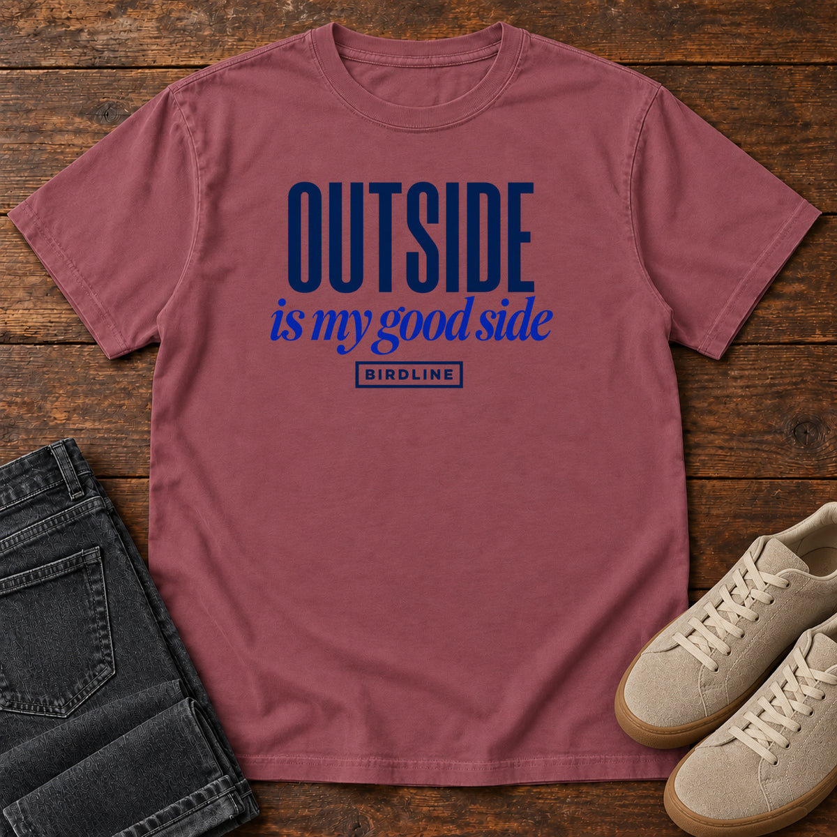Brick Outside Is My Good Side T-Shirt with dark blue block-and-script lettering, front flat lay on wood.