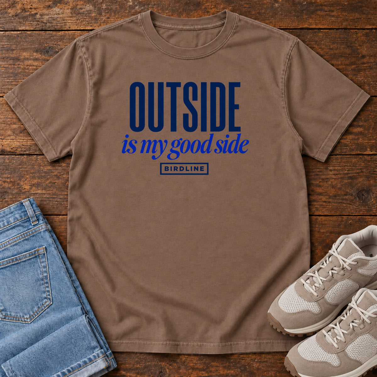 Espresso Outside Is My Good Side T-Shirt with dark blue block-and-script lettering, front flat lay on wood.