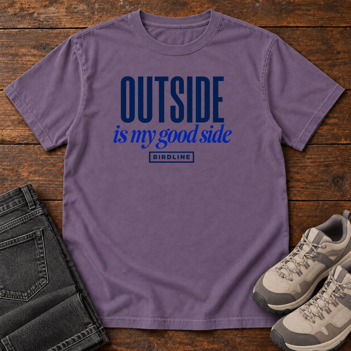 Grape Outside Is My Good Side T-Shirt with dark blue block-and-script lettering, front flat lay on wood.