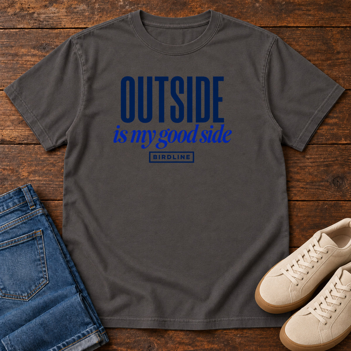 Graphite Outside Is My Good Side T-Shirt with dark blue block-and-script lettering, front flat lay on wood.