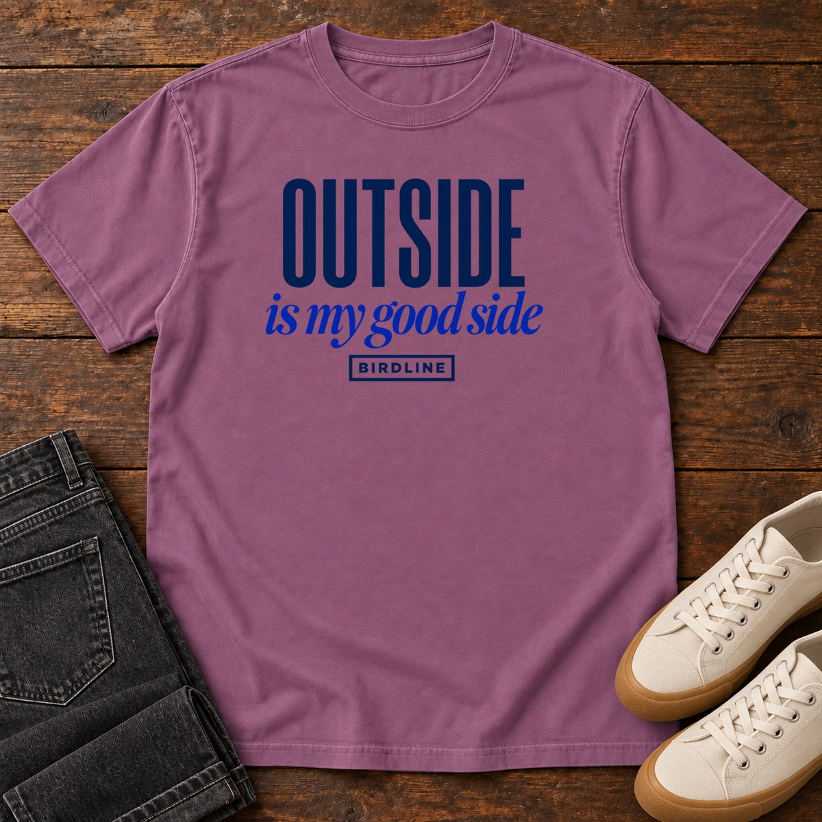 Berry Outside Is My Good Side T-Shirt with dark blue block-and-script lettering, front flat lay on wood.