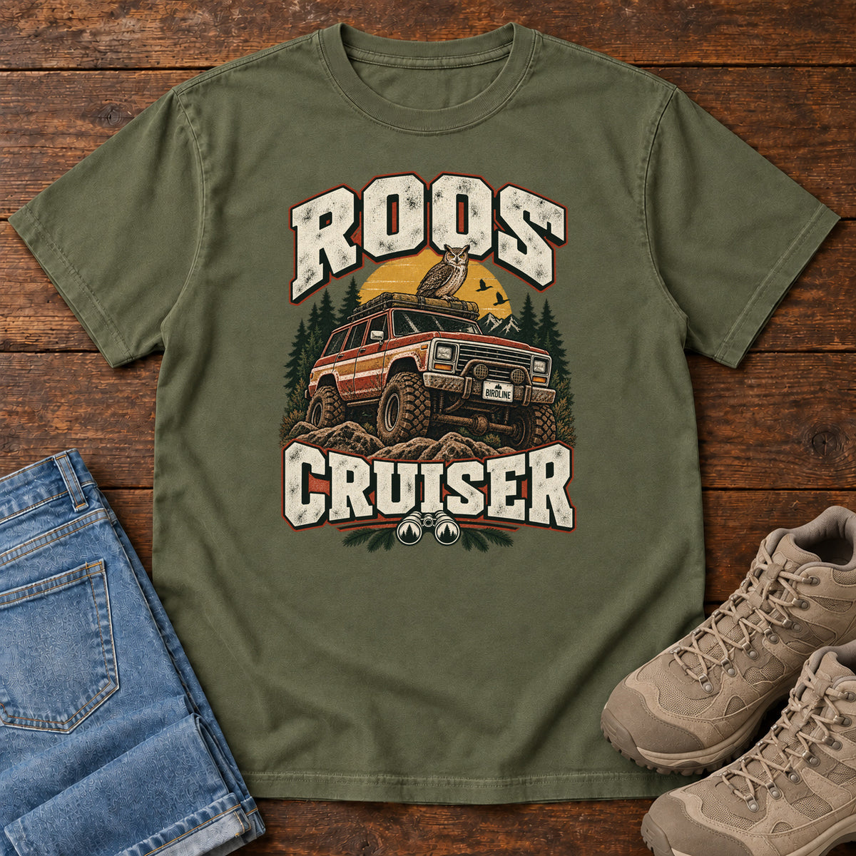 Hemp Roos Cruiser T-Shirt with a bird perched on an off-road vehicle between distressed cream Roos Cruiser lettering, front flat lay on wood.